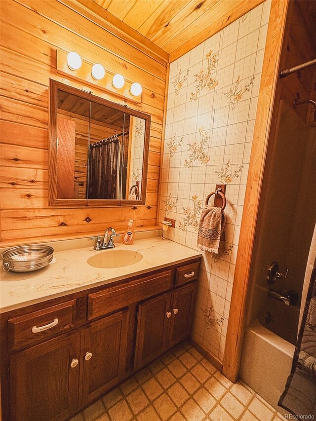 bathroom with vanity, shower / tub combo with curtain, wood ceiling, and wood walls