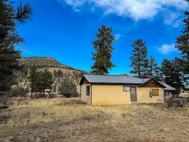 view of side of home with a mountain view