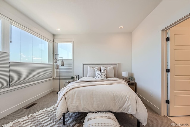 carpeted bedroom with recessed lighting, baseboards, and visible vents