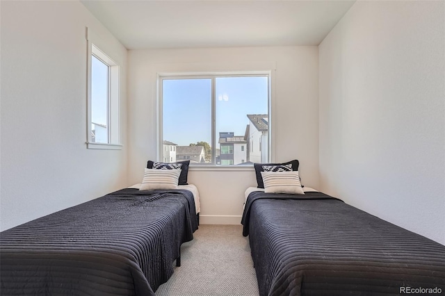 carpeted bedroom featuring baseboards