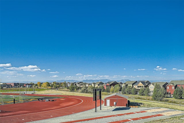 surrounding community featuring a mountain view, a residential view, and fence