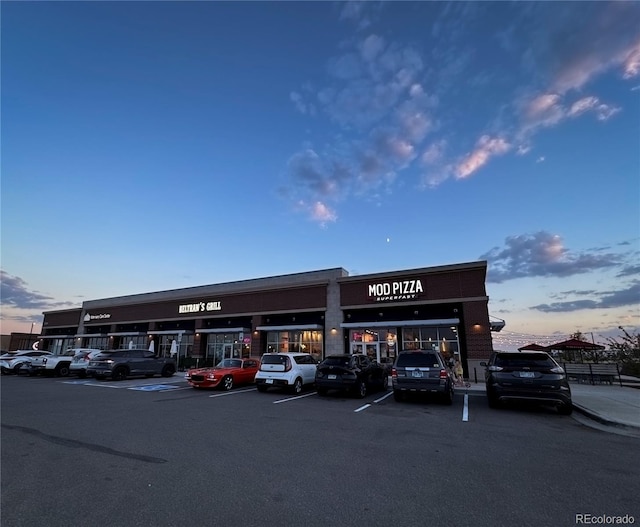 property at dusk with uncovered parking