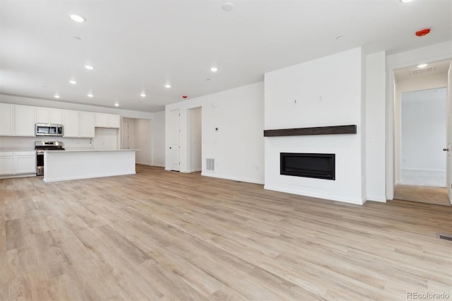 unfurnished living room with light wood-type flooring