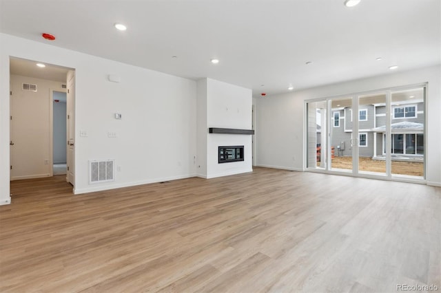 unfurnished living room with light hardwood / wood-style floors