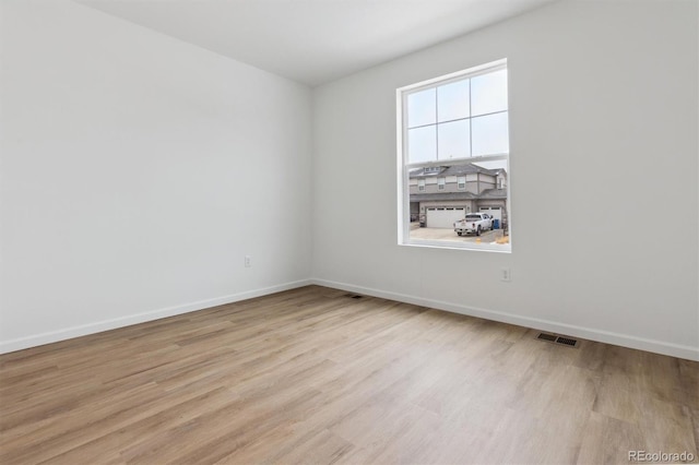 unfurnished room featuring light hardwood / wood-style floors