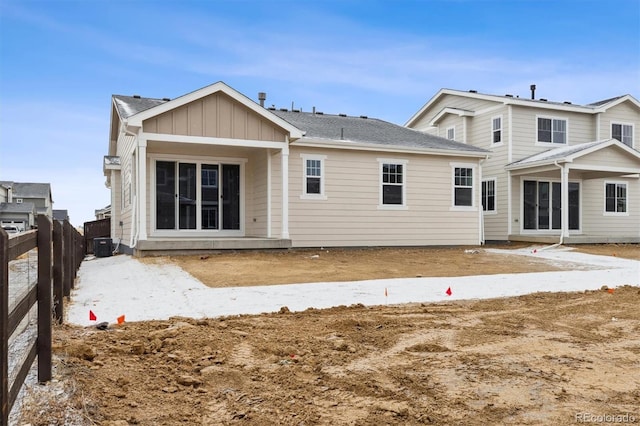 rear view of house with central AC unit