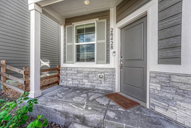 view of exterior entry featuring stone siding