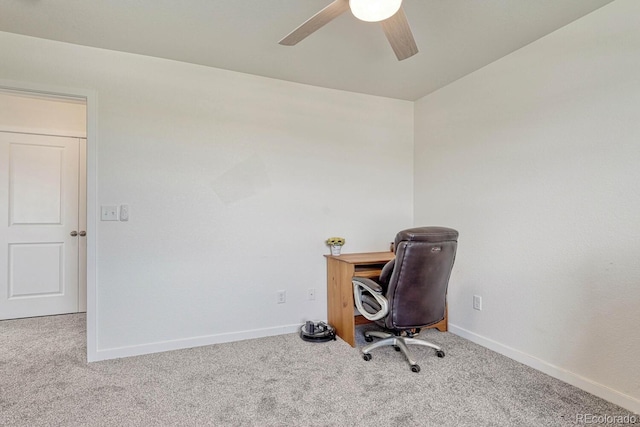 carpeted office with ceiling fan and baseboards