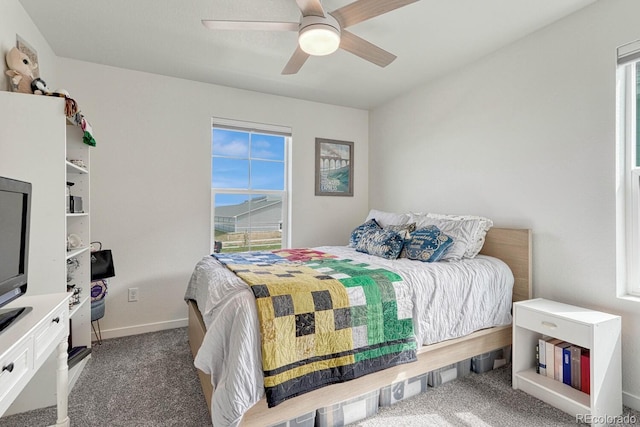 bedroom featuring dark carpet, baseboards, and ceiling fan