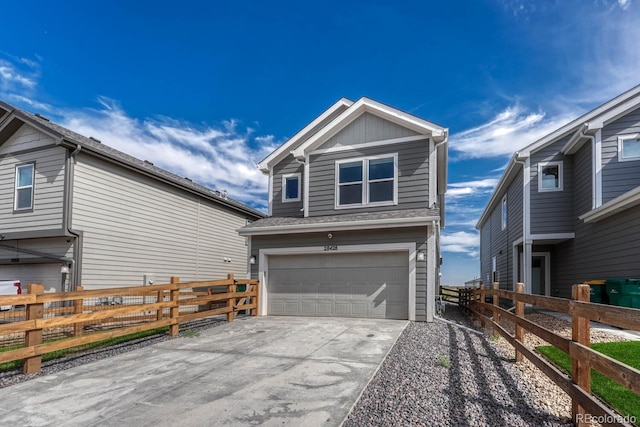 view of front facade with driveway, roof with shingles, an attached garage, fence, and board and batten siding