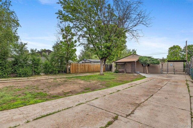 530 S Quitman St, Denver, CO 80219 - view of yard with concrete driveway