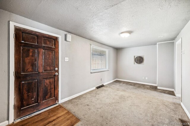 530 S Quitman St, Denver, CO 80219 - entryway featuring carpet flooring, baseboards, and a textured ceiling