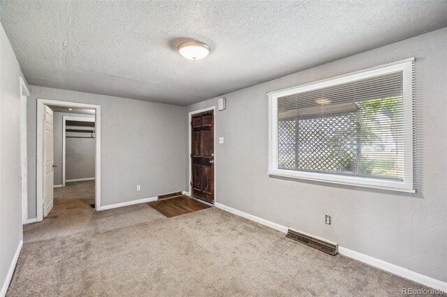 530 S Quitman St, Denver, CO 80219 - carpeted empty room featuring baseboards and a textured ceiling