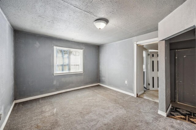 530 S Quitman St, Denver, CO 80219 - unfurnished room with carpet, a textured ceiling, and baseboards