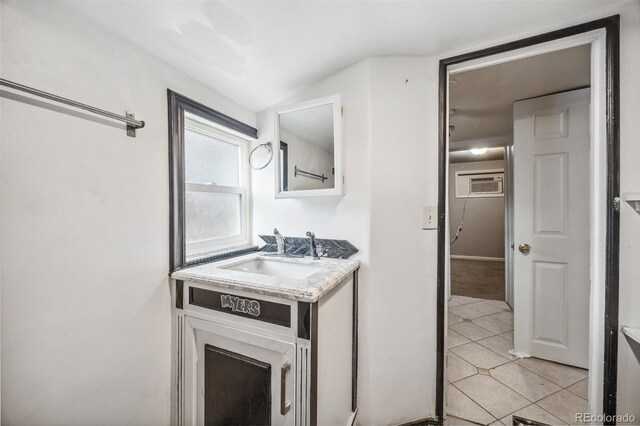 530 S Quitman St, Denver, CO 80219 - bathroom featuring vanity, a wall unit AC, tile patterned floors, and lofted ceiling