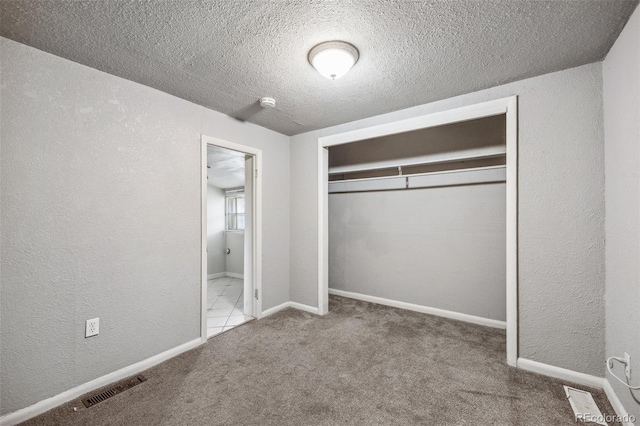 530 S Quitman St, Denver, CO 80219 - unfurnished bedroom featuring carpet floors, a textured wall, a textured ceiling, a closet, and baseboards