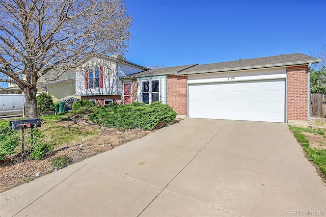 1796 S Yampa Way, Aurora, CO 80017 - tri-level home with driveway, brick siding, and a garage