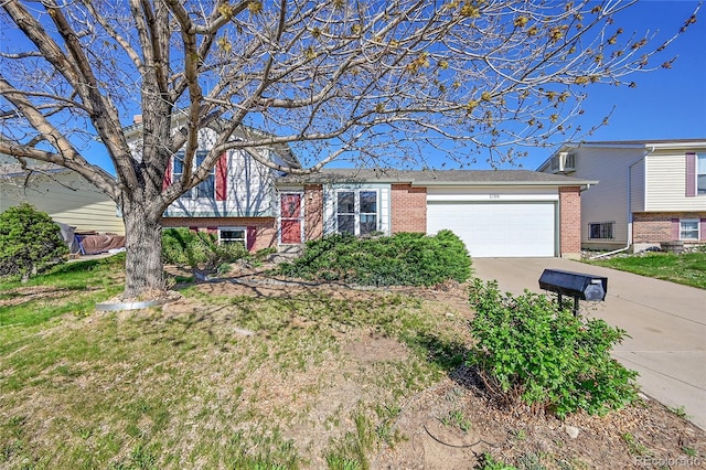 1796 S Yampa Way, Aurora, CO 80017 - split level home with brick siding, a garage, and driveway
