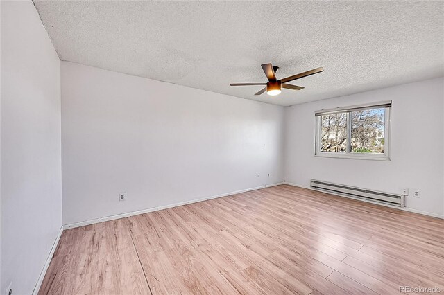 1796 S Yampa Way, Aurora, CO 80017 - empty room with baseboard heating, a ceiling fan, a textured ceiling, light wood finished floors, and baseboards