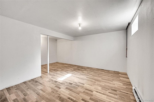 1796 S Yampa Way, Aurora, CO 80017 - finished below grade area with a baseboard radiator and light wood-style floors