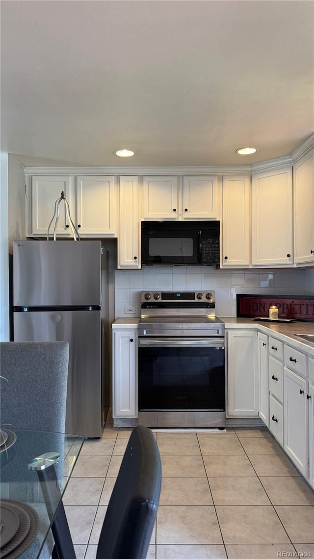 1796 S Yampa Way, Aurora, CO 80017 - kitchen with appliances with stainless steel finishes, white cabinets, light tile patterned flooring, decorative backsplash, and recessed lighting