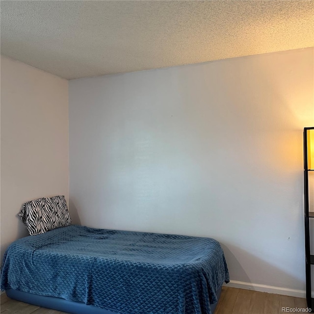 1796 S Yampa Way, Aurora, CO 80017 - bedroom featuring light wood-style flooring and a textured ceiling
