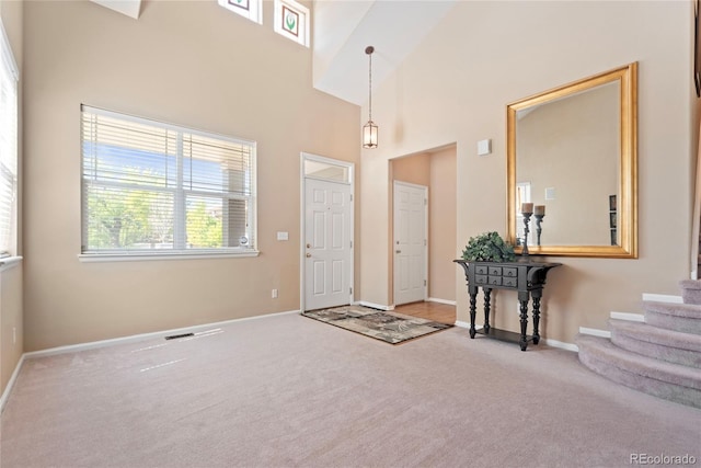 9290 Melborne Ct, Parker, CO 80134 - foyer with carpet, a towering ceiling, baseboards, and stairs