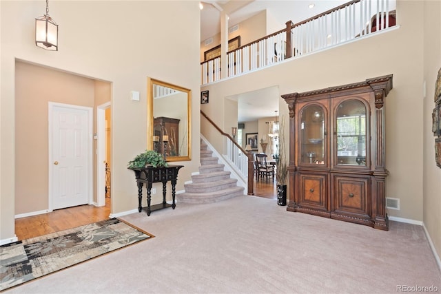 9290 Melborne Ct, Parker, CO 80134 - foyer entrance featuring carpet flooring, baseboards, a towering ceiling, and stairway