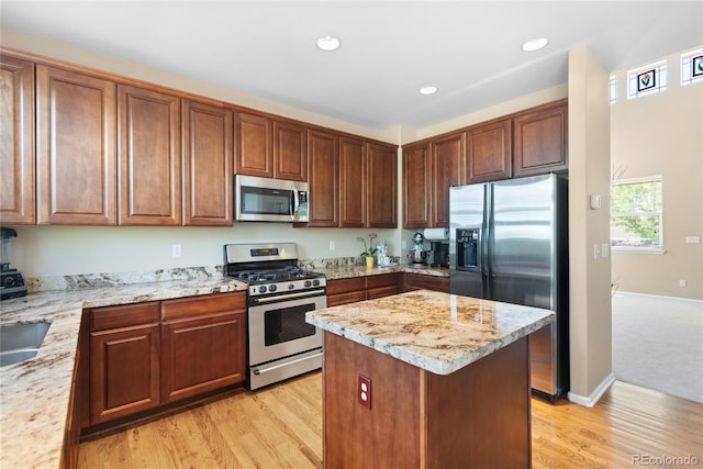 9290 Melborne Ct, Parker, CO 80134 - kitchen featuring stainless steel appliances, light wood-style floors, light stone countertops, a center island, and recessed lighting