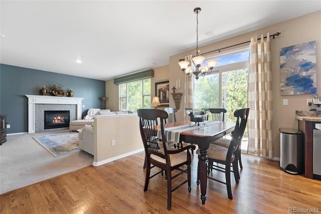 9290 Melborne Ct, Parker, CO 80134 - dining area featuring a chandelier, light wood finished floors, a fireplace, and baseboards