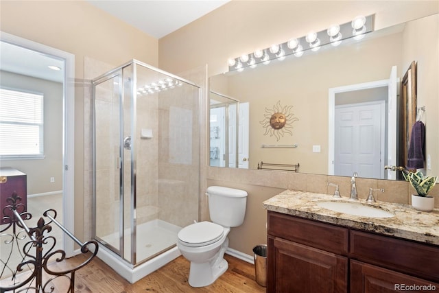9290 Melborne Ct, Parker, CO 80134 - full bath featuring vanity, a stall shower, toilet, wood finished floors, and baseboards
