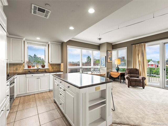 400 E 3rd Ave Unit 305, Denver, CO 80203 - kitchen with open shelves, open floor plan, recessed lighting, decorative backsplash, and crown molding