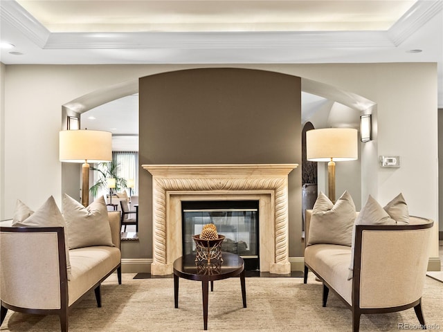 400 E 3rd Ave Unit 305, Denver, CO 80203 - living area featuring arched walkways, a fireplace with flush hearth, crown molding, recessed lighting, and a tray ceiling