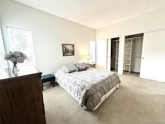 4493 Dunkirk Way, Denver, CO 80249 - bedroom with carpet flooring, two closets, and a textured ceiling