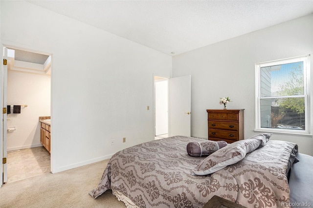 4493 Dunkirk Way, Denver, CO 80249 - bedroom featuring light carpet, ensuite bathroom, and baseboards