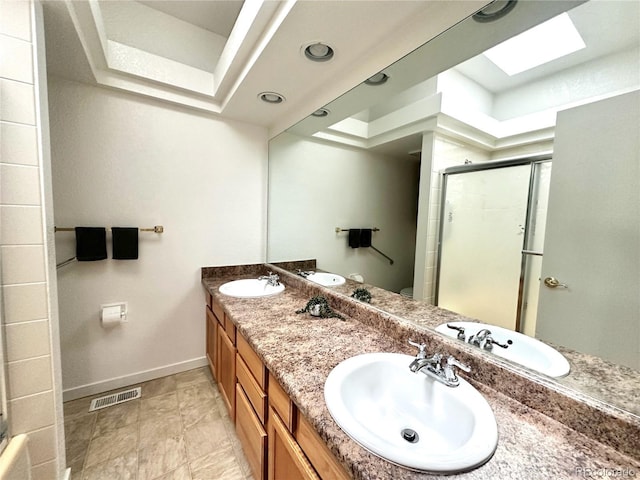 4493 Dunkirk Way, Denver, CO 80249 - bathroom with baseboards, a stall shower, double vanity, and a skylight