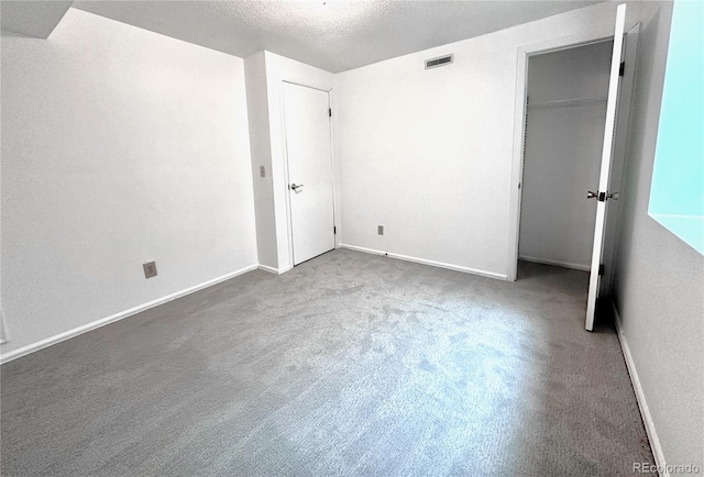 4493 Dunkirk Way, Denver, CO 80249 - unfurnished bedroom featuring carpet, baseboards, and a textured ceiling