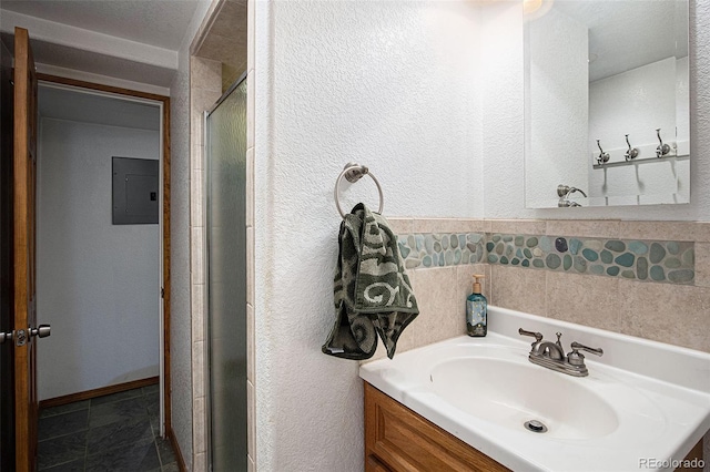 bathroom featuring walk in shower, electric panel, and sink