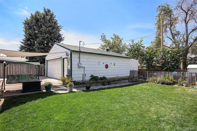 exterior space with an outbuilding, a garage, and a yard