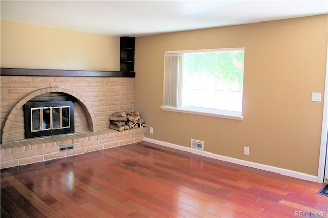 7891 Poplar St, Commerce City, CO 80022 - unfurnished living room featuring wood finished floors and a fireplace