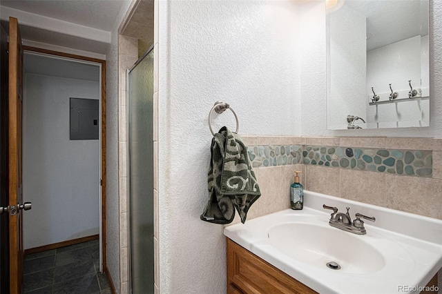 7891 Poplar St, Commerce City, CO 80022 - bathroom with electric panel, a textured wall, a shower stall, and vanity