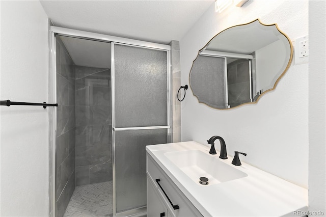 bathroom featuring vanity and a shower with shower door