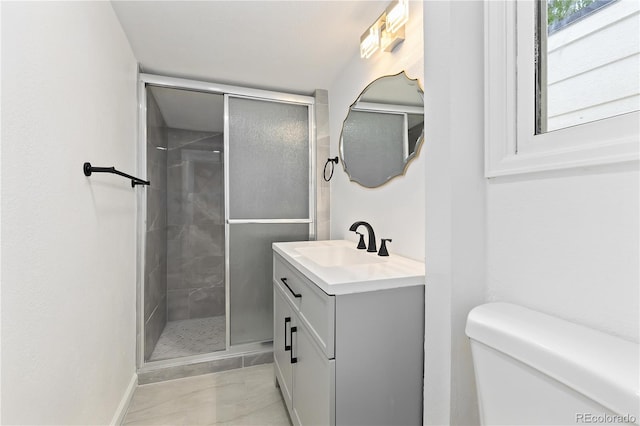 bathroom with tile patterned floors, an enclosed shower, vanity, and toilet