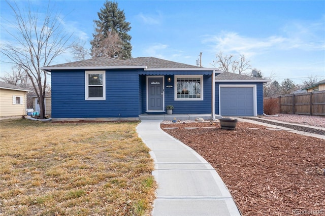 view of front facade featuring driveway, a shingled roof, an attached garage, fence, and a front lawn