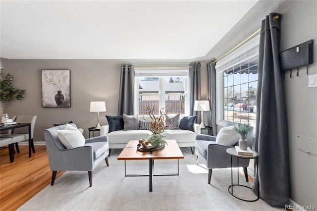 living room with baseboards and light wood-style floors