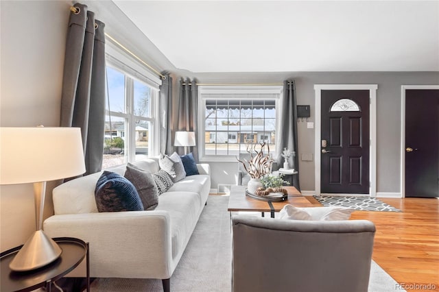 living room featuring baseboards and wood finished floors