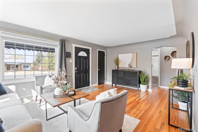 living room featuring light wood-type flooring and baseboards