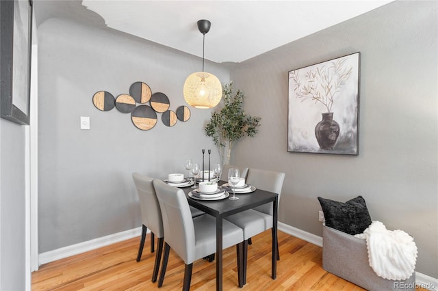 dining area with wood finished floors and baseboards