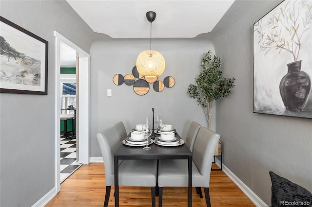 dining area featuring wood finished floors and baseboards