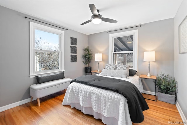 bedroom with ceiling fan, baseboards, and wood finished floors